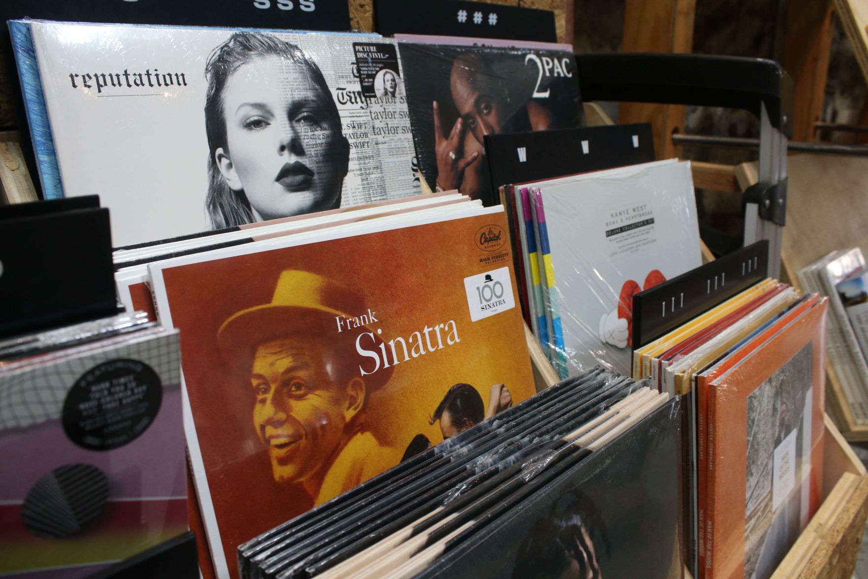 Vinyl album covers line the wooden shelves at Urban Outfitters